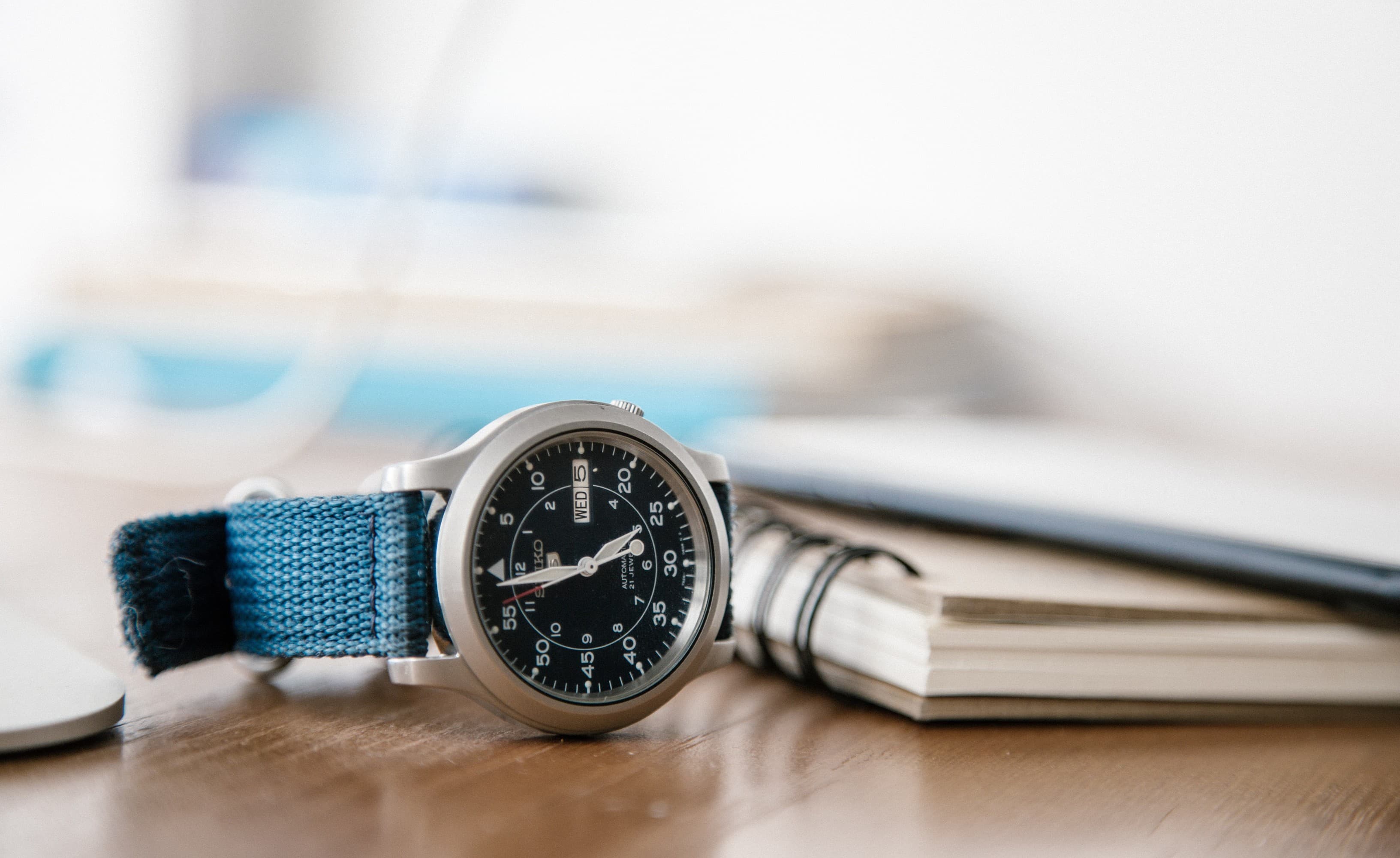 Watch next to some notebooks