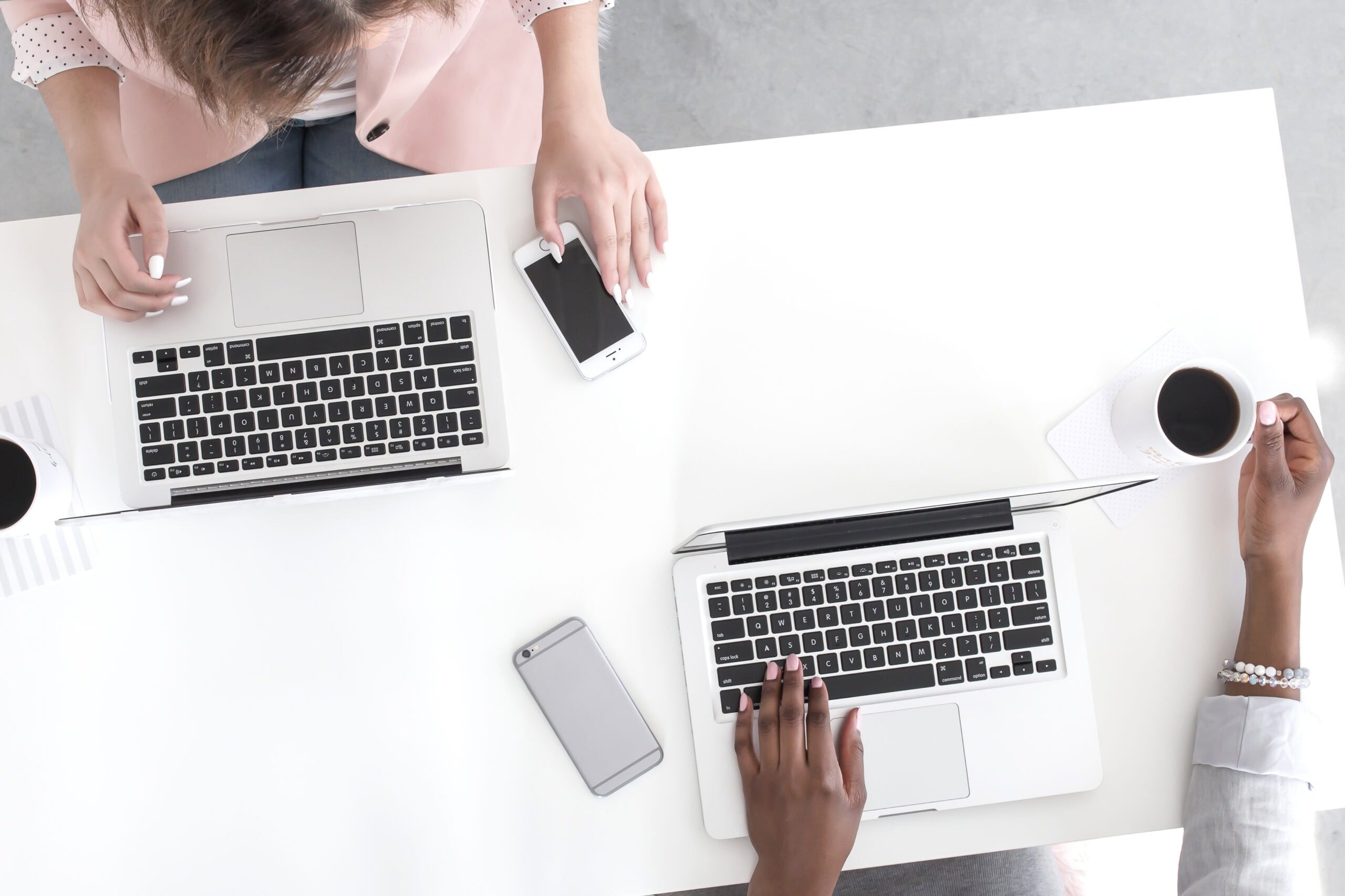 Overhead shot of 2 women on laptops